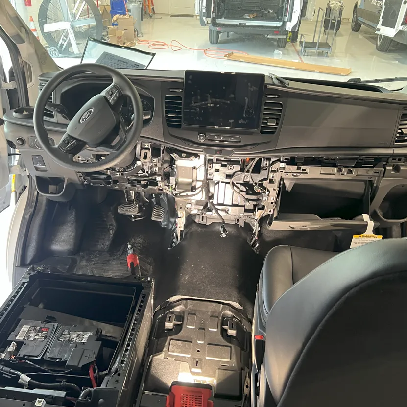 The interior of a Ford vehicle torn down to install a custom switch module for the operator.